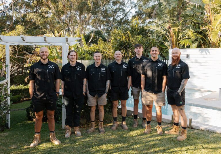 The ZC Plumbing & Bathroom Solutions team standing together in a garden in Terrigal