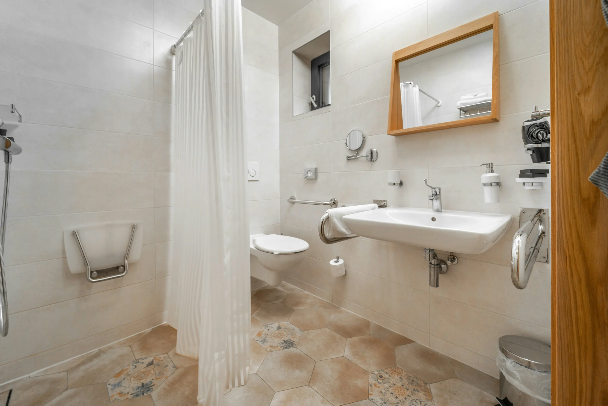 Accessible bathroom with grab rails, a fold-down shower seat and level-access shower