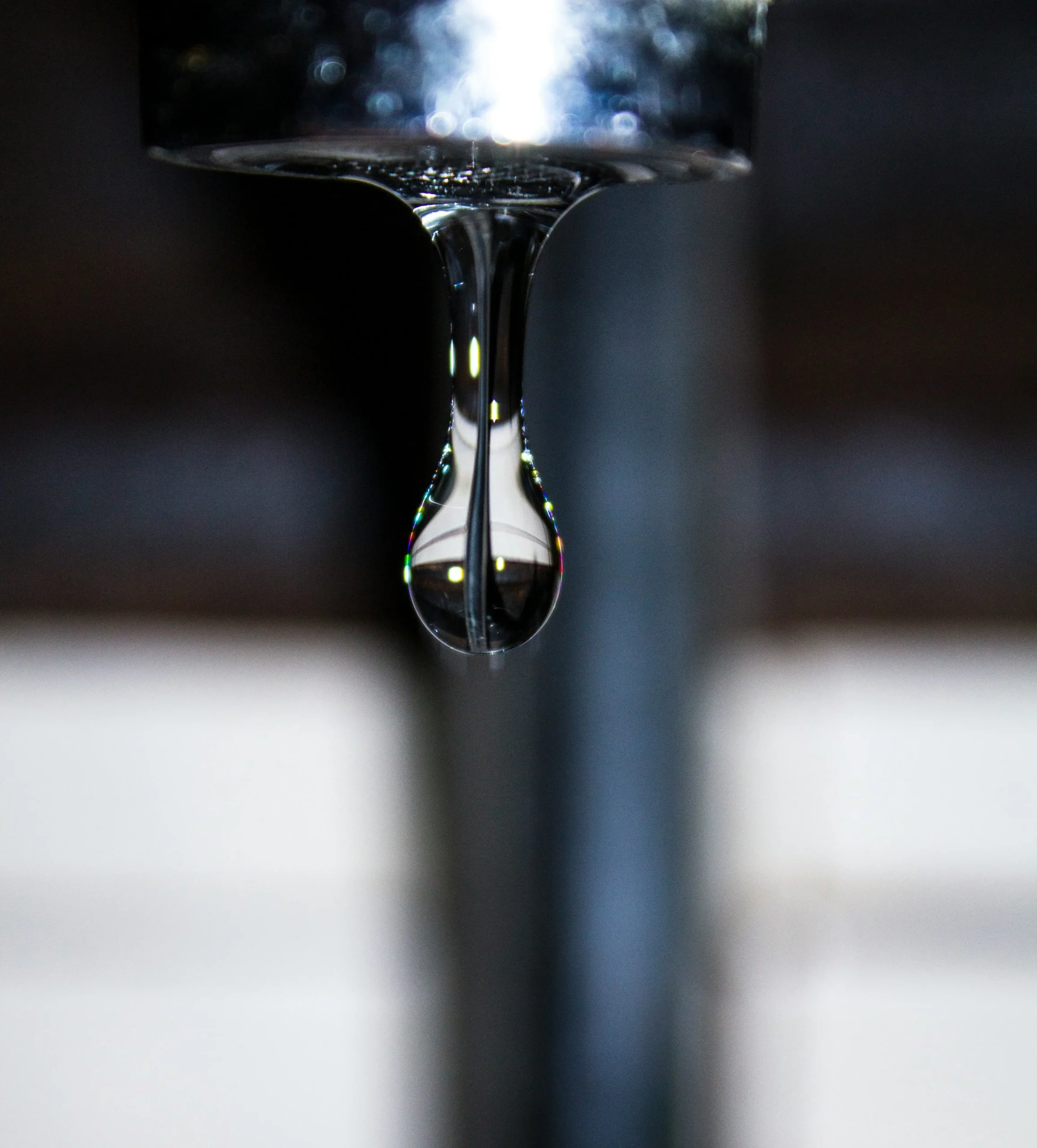Close-up of a water drop falling from a dripping tap