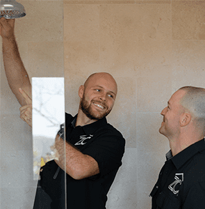 Zac Christensen from ZC Plumbing & Bathroom Solutions installing shower head