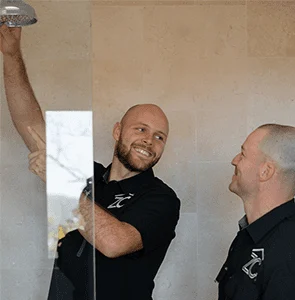 Zac Christensen from ZC Plumbing & Bathroom Solutions installing a shower head