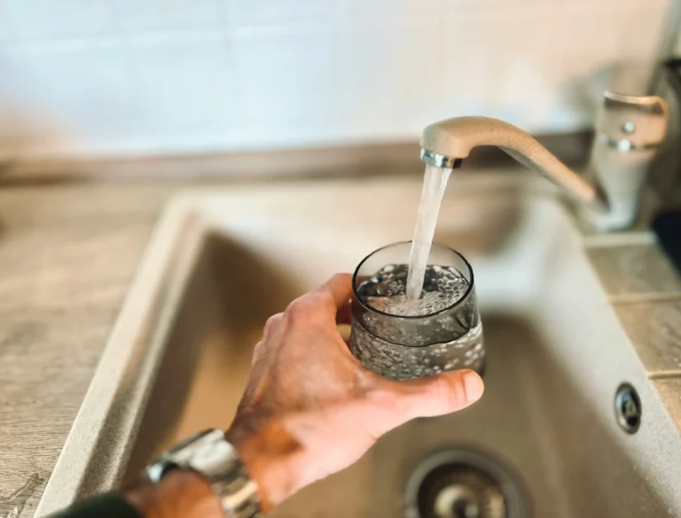 Glass of drinking water filled at a kitchen tap